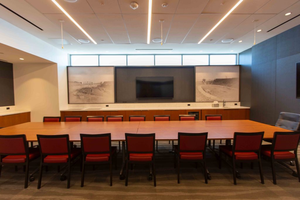 conference table with chairs and TV on wall