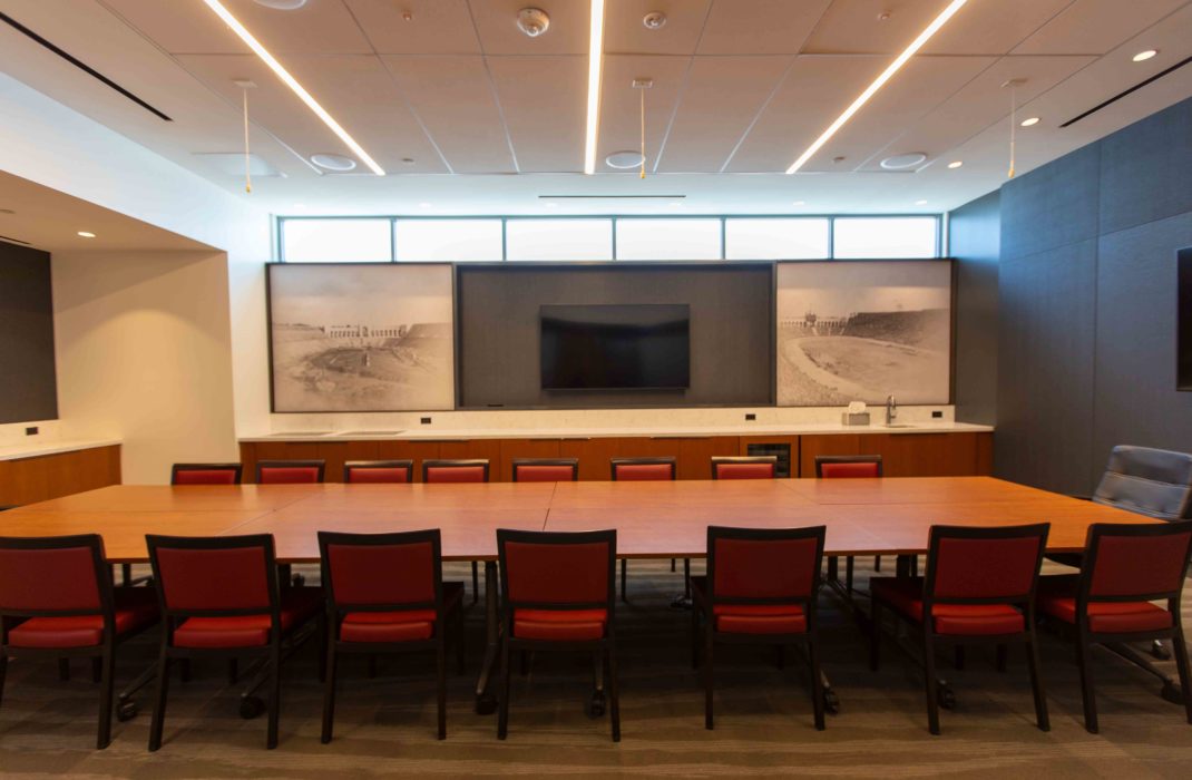 conference table with chairs and TV on wall