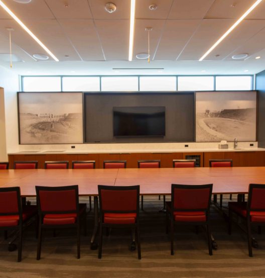 conference table with chairs and TV on wall