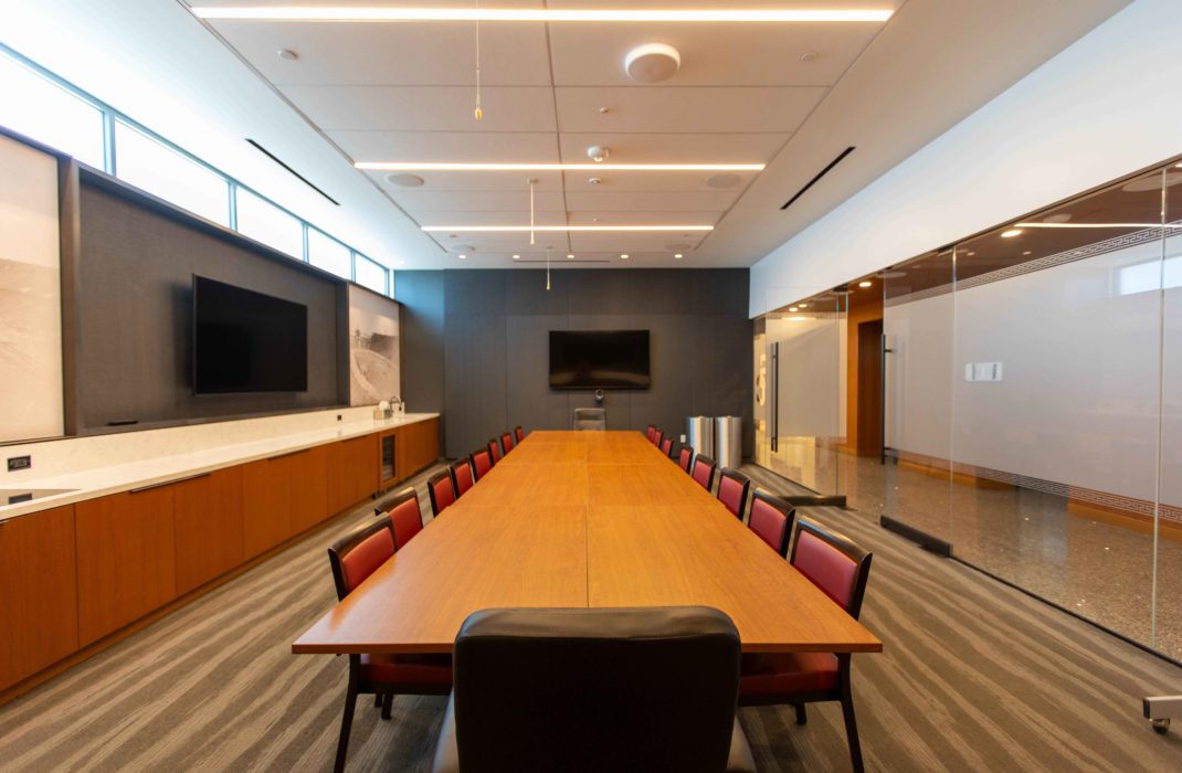 conference table with chairs and TV on wall