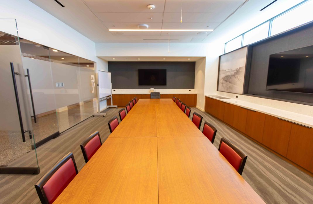 conference table with chairs and TV on wall